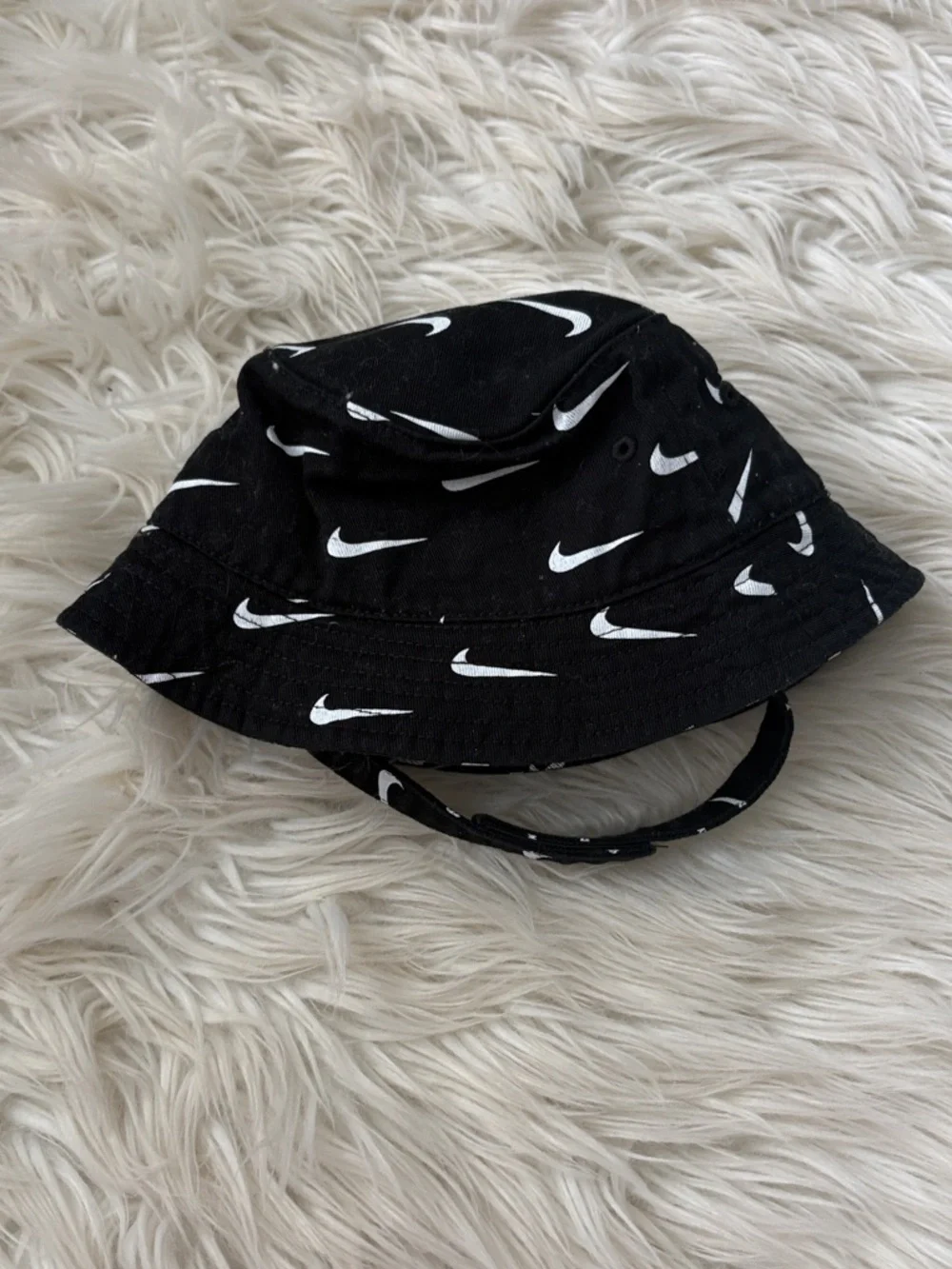 Nike Black Bucket Hat with White Swoosh Pattern - infant